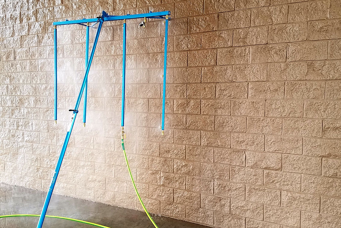 water spray rack conducting water penetration test on brick wall